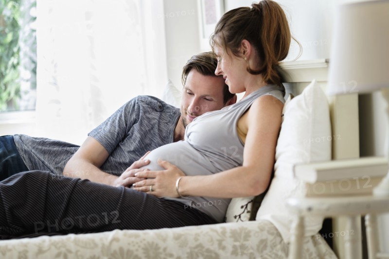 Couple lying in bed.
