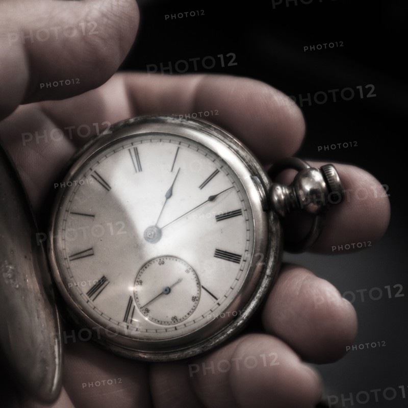 Pocket watch in man's hand.