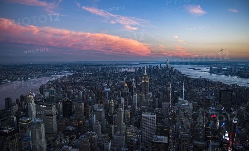 Aerial view of downtown district at sunset. USA, New York, New York City.