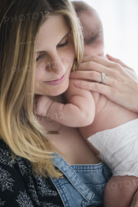 Mother holding baby girl (2-5 months) in her arms