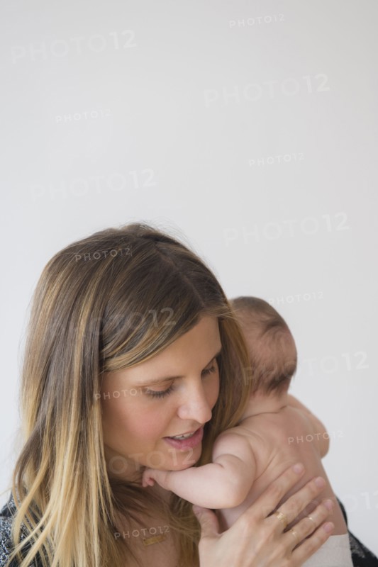 Mother holding baby girl (2-5 months) in her arms