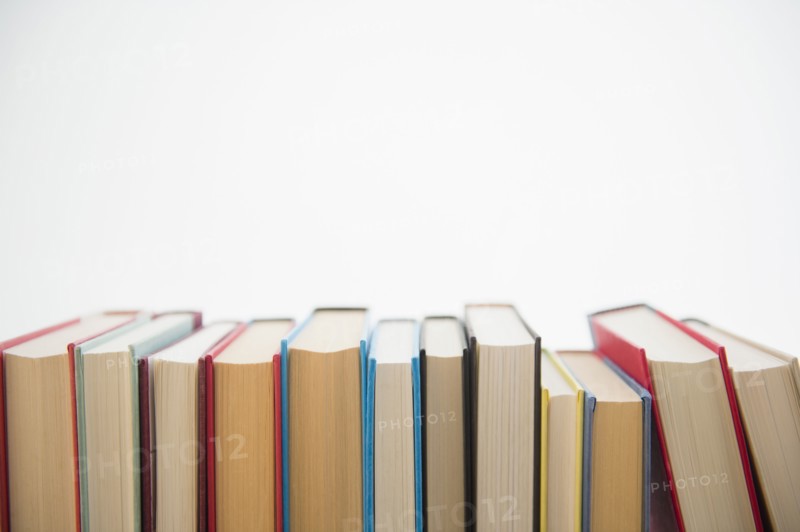 Row of books on white background