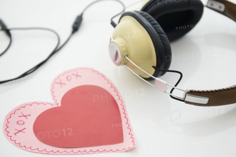Studio shot of heart shaped paper cutout and headphones