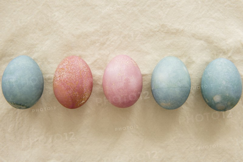 Dyed Easter eggs in a row on beige