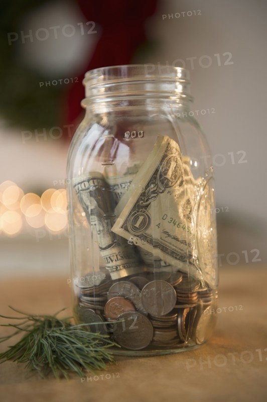 Jar with dollar bills and coins
