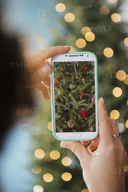 Personal perspective of person photographing Christmas tree