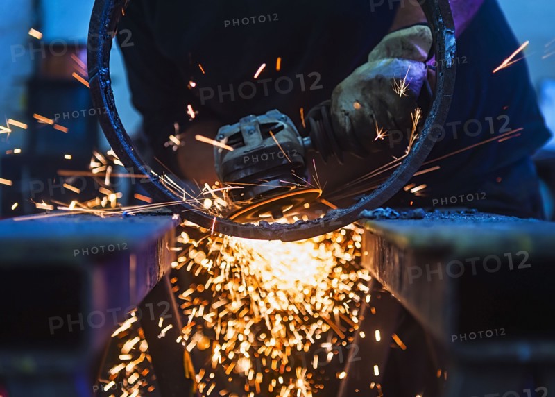 Welder working in metal workshop