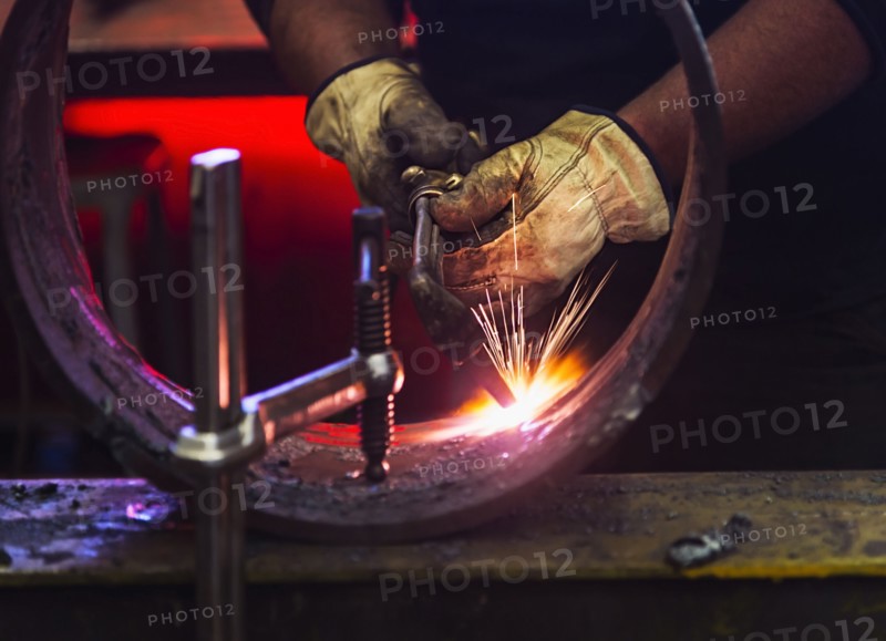Welder working in metal workshop