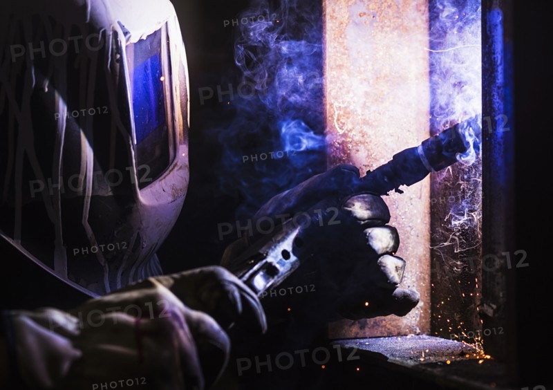 Man in welding mask working