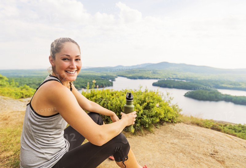 Smiling young female hiker resting