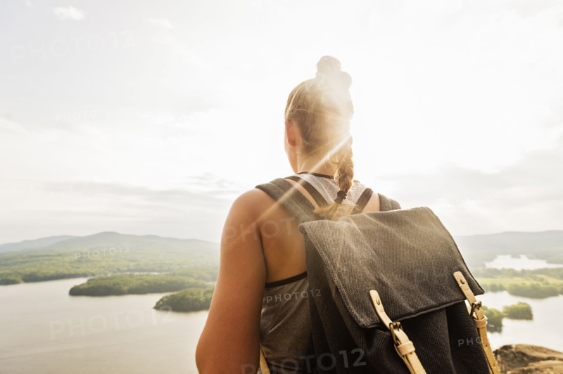 Rear view of young woman looking at lake