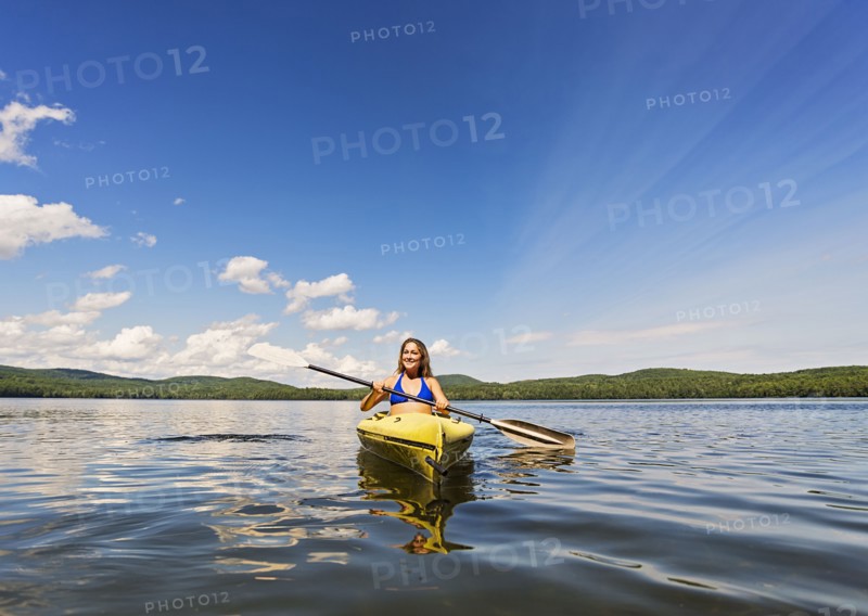 Young woman kayaking on lake