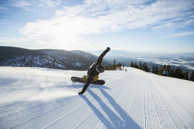 Man snowboarding downhill