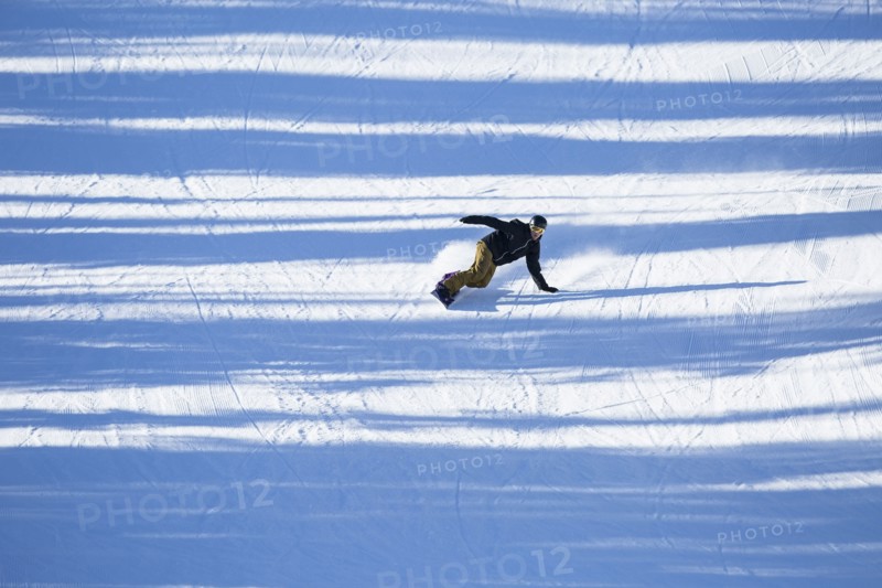 Man snowboarding downhill