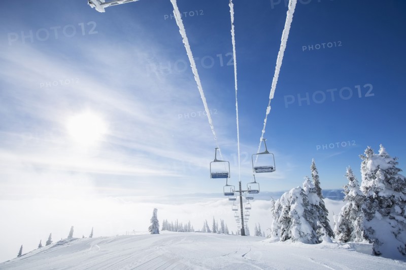 Ski lift at sunlight against blue ski