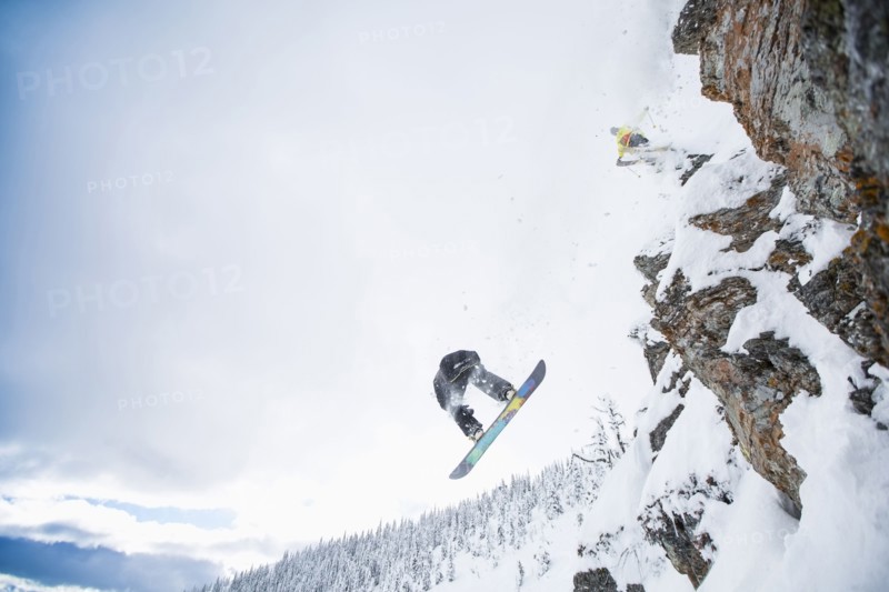 Low angle view of two men jumping from ski slope