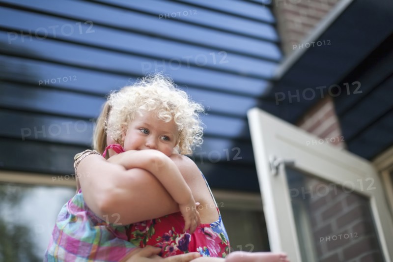 Smiley daughter (4-5) hugging mother