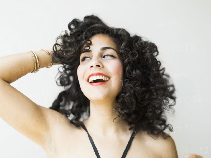 Portrait of smiling woman with dark curly hair