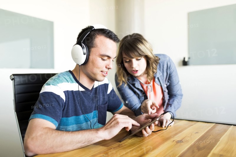 Man showing woman his music on smart phone