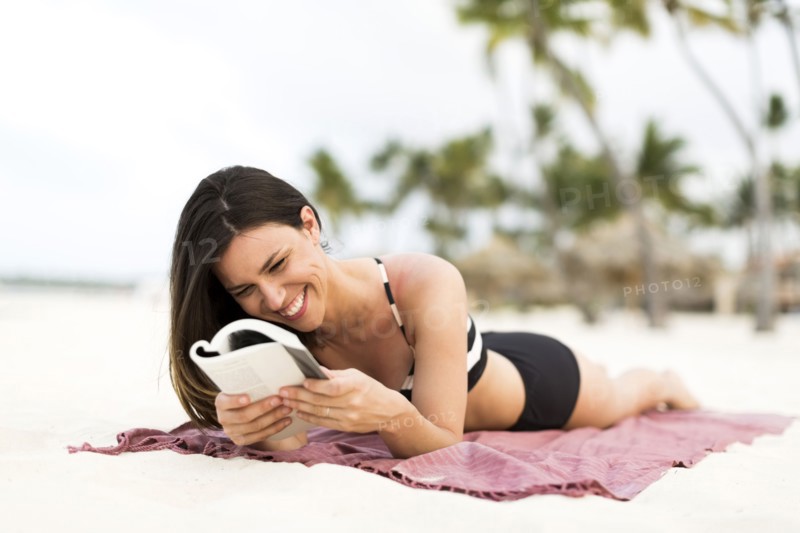 Woman in bikini relaxing on beach