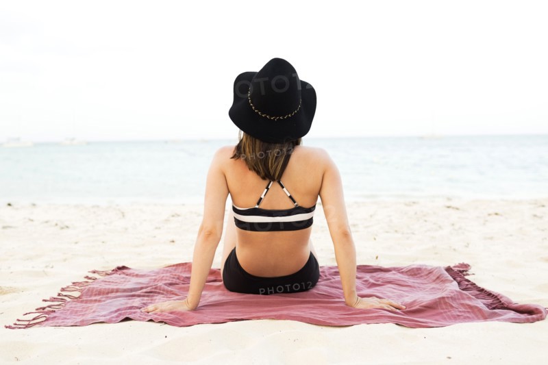Woman in bikini relaxing on beach