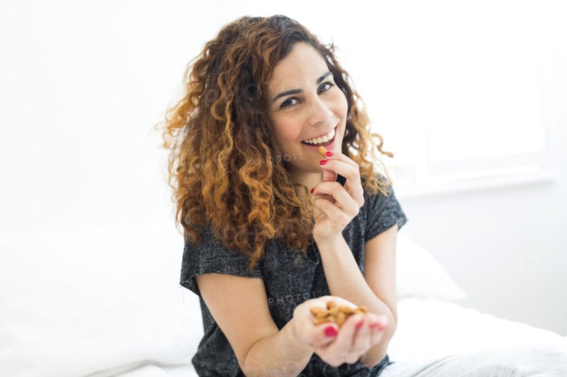 Woman eating almonds