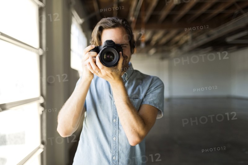 Portrait of man with digital camera