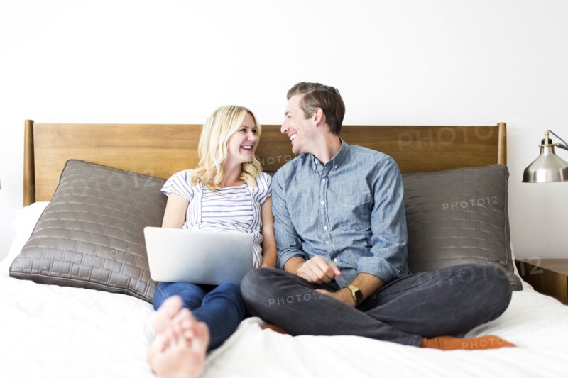 Couple sitting on bed