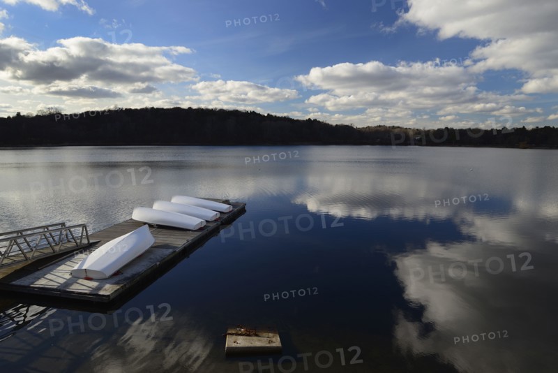 Cloud reflection over boat dock Jamaica Pond