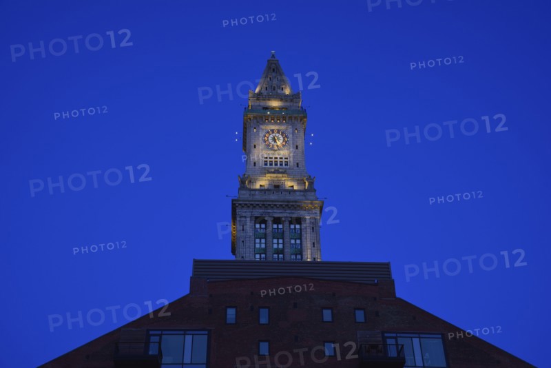 Illuminated clock tower at dawn
