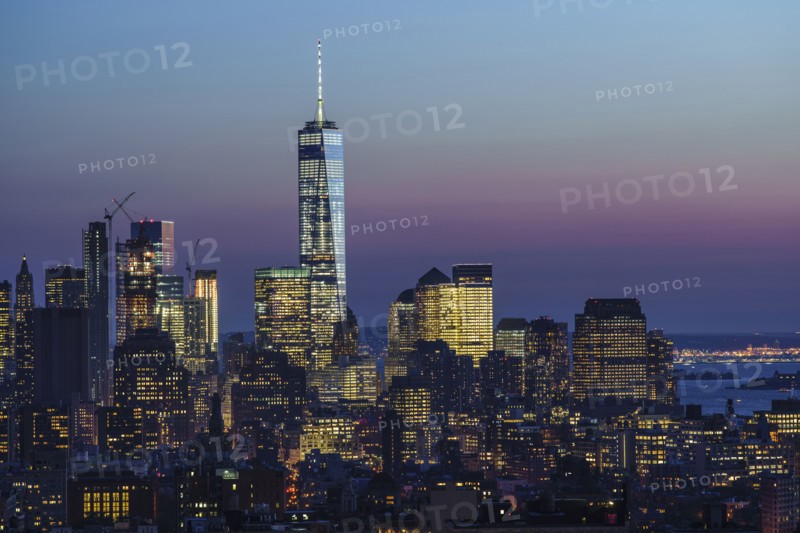 Illuminated skyline at sunrise. New York City, New York, USA.