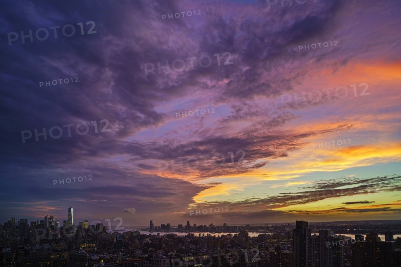 Dramatic sky over city at sunset. New York City, New York, USA.