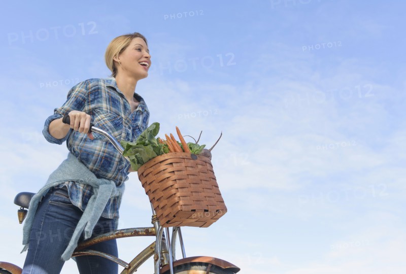 Portrait of young woman with bicycle.