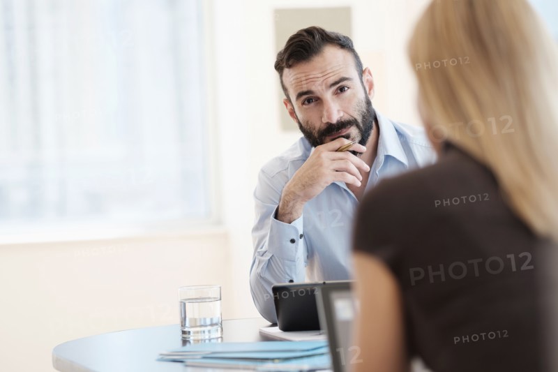 Man and woman sitting in office.