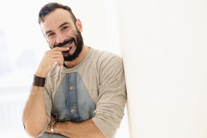 Portrait of bearded man looking at camera.