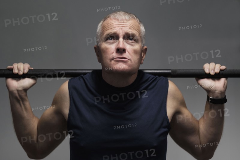 Man in health club weight lifting.