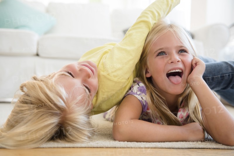 Boy (4-5) and girl (6-7) playing on floor