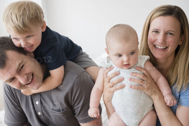 Portrait of parents with son (2-3) and baby daughter (12-17 months)