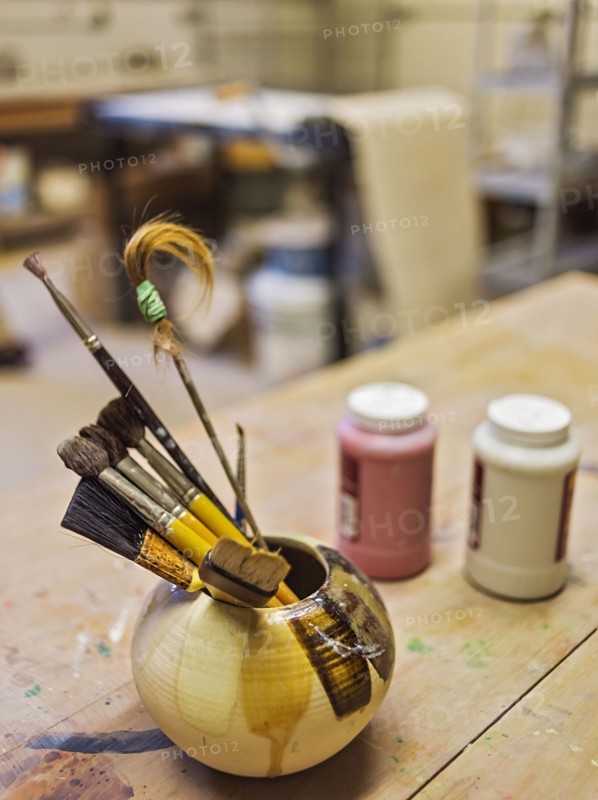 Brushes in bowl in art studio