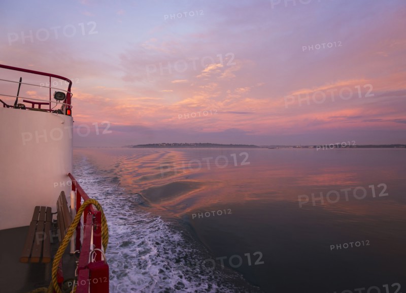 View from ferry towards sea at sunrise