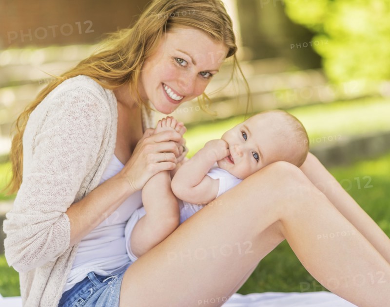 Mother holding baby (6-11 months) on lap