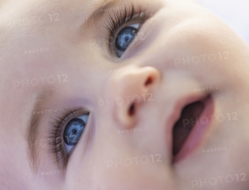 Close-of baby boy's (6-11 months) smiling face