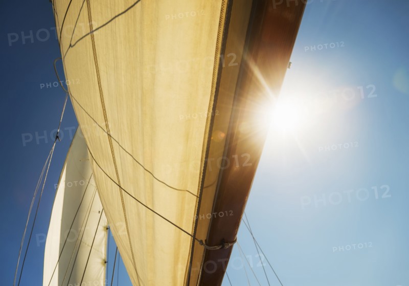 Close-up of sun shining through boat's sail