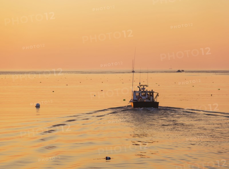 Boat on sea at sunrise