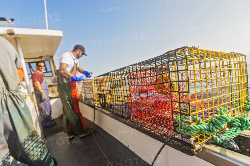 Three fishermen working on boat