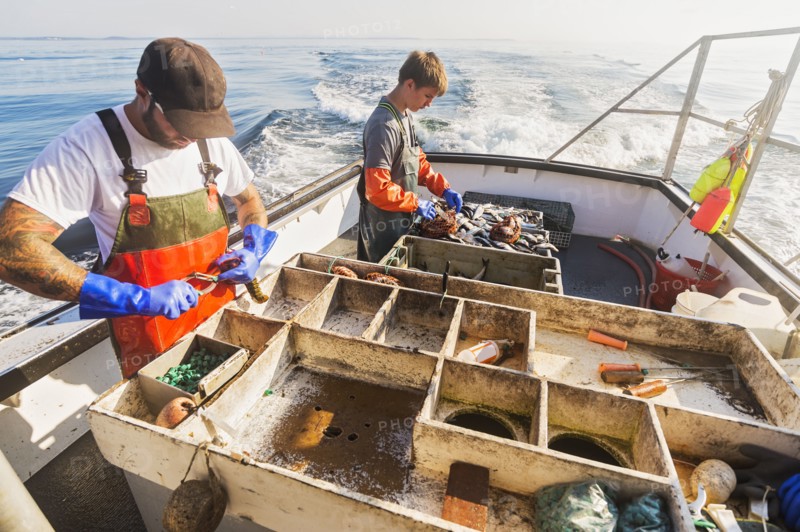 Two fishermen working on boat