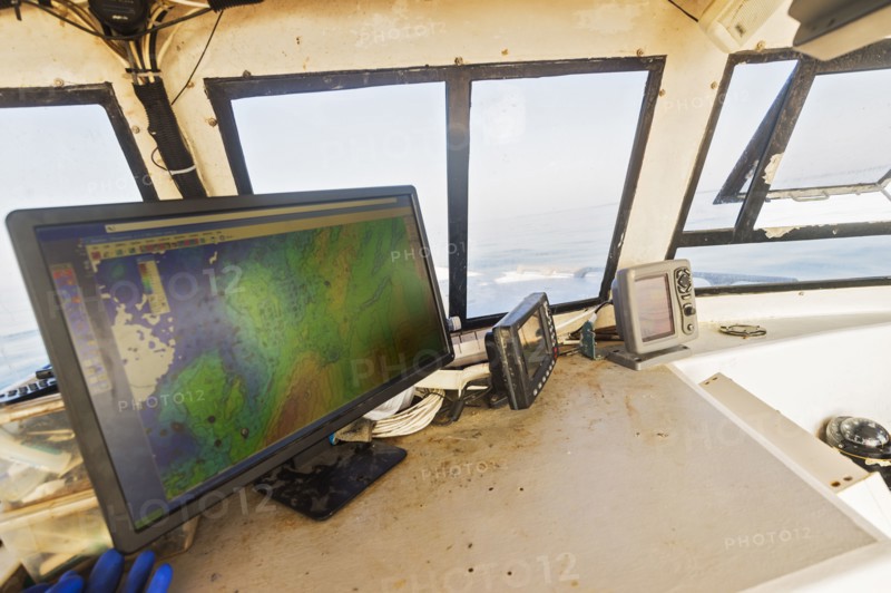 Directions on device screen inside fishing boat