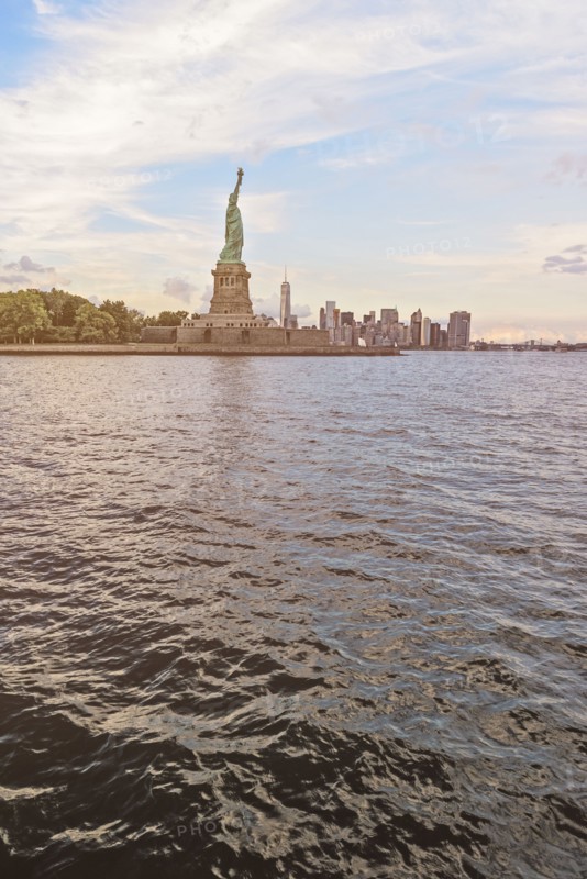 Statue of Liberty and financial district at dusk