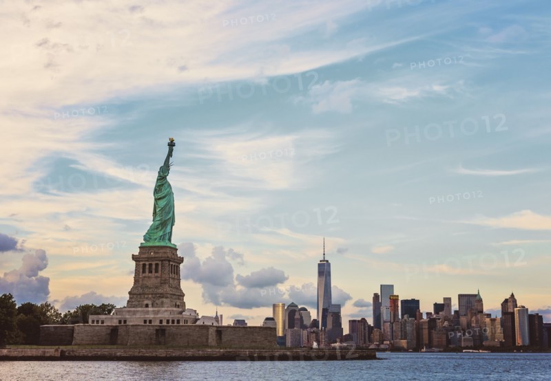 Statue of Liberty and financial district at dusk