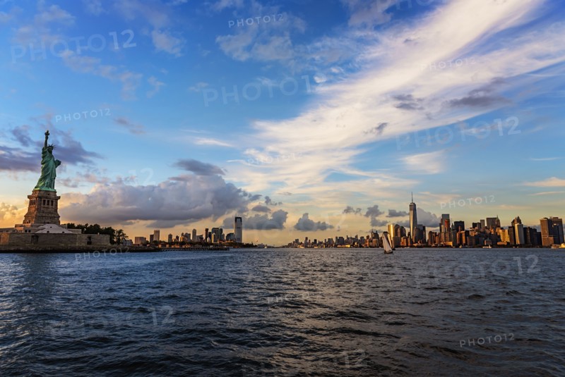 Statue of Liberty and financial district at dusk
